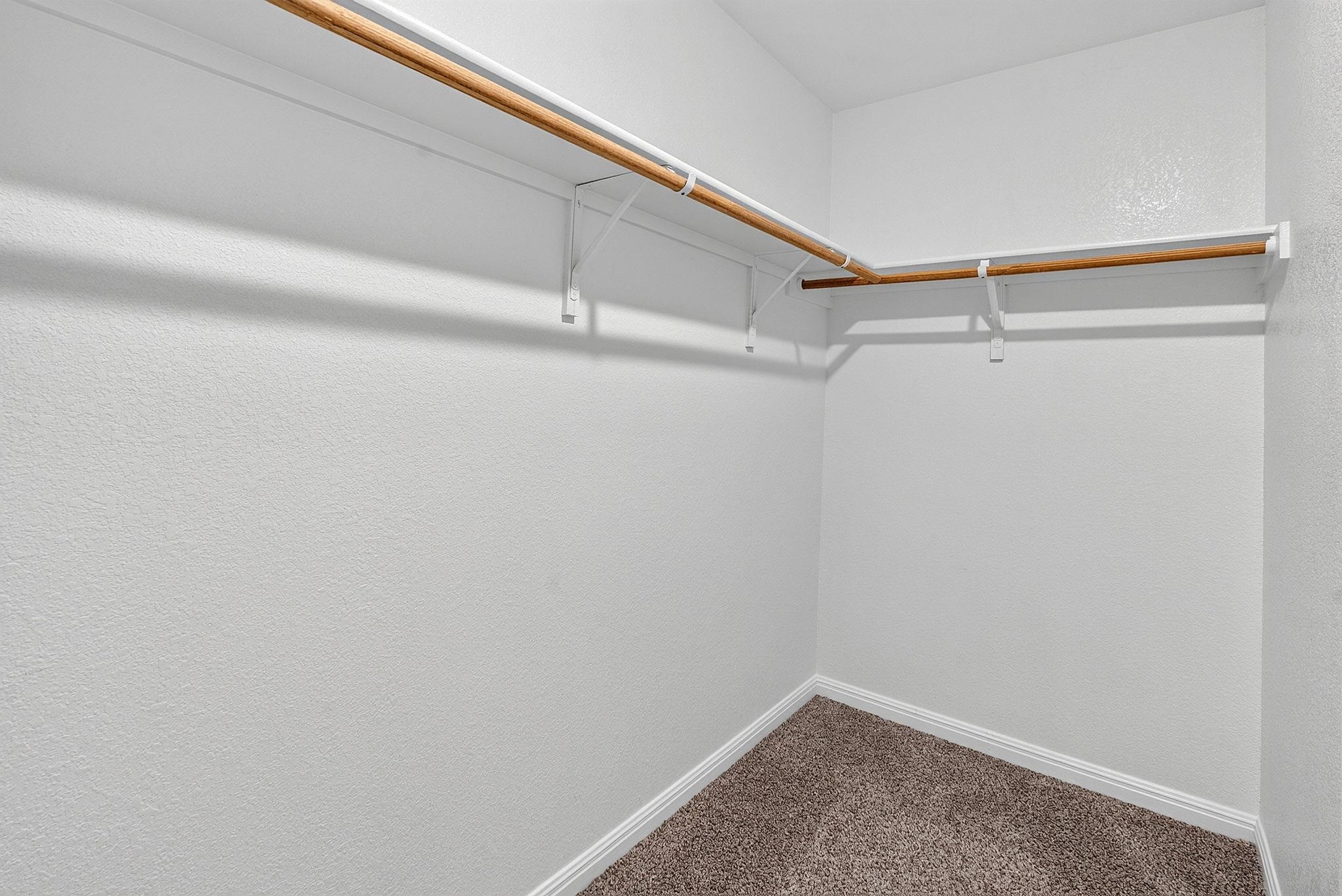 Soft carpeting underfoot defines this well-designed wardrobe storage area.