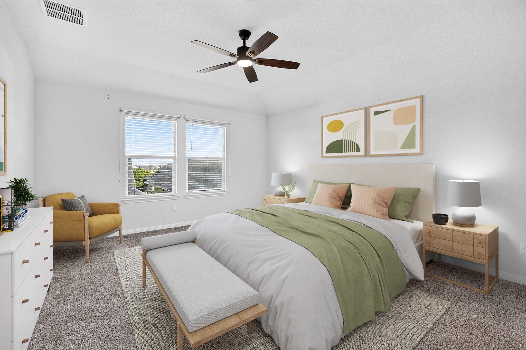 Plentiful natural light fills this bedroom through dual windows over soft carpeting.