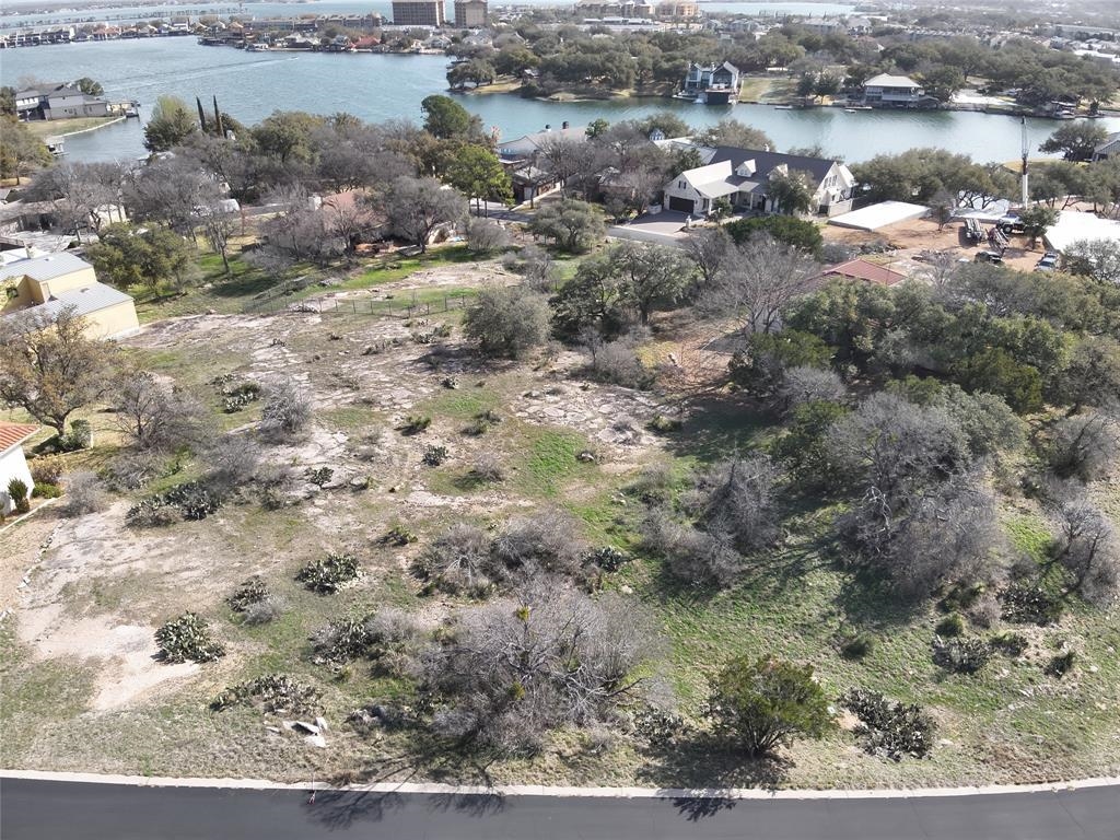 Aerial view of property and surrounding area with a large body of water