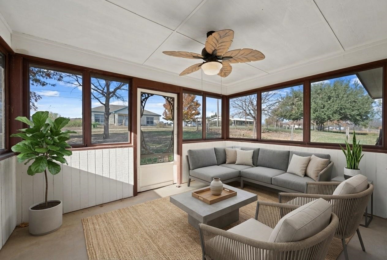 Sunroom / solarium featuring a ceiling fan. *Virtually Staged