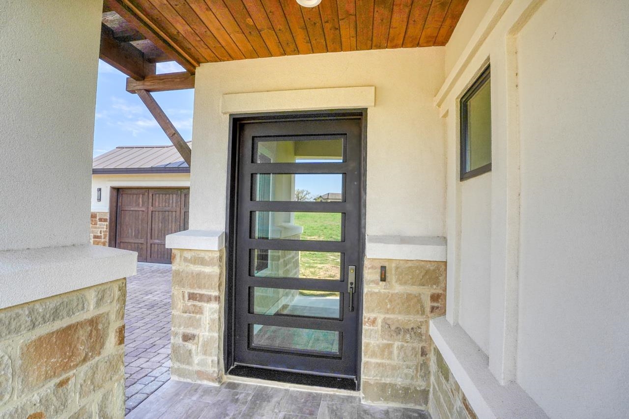 Custom iron door is your gateway to a beautiful Neiman Foster custom home upscale finishings.