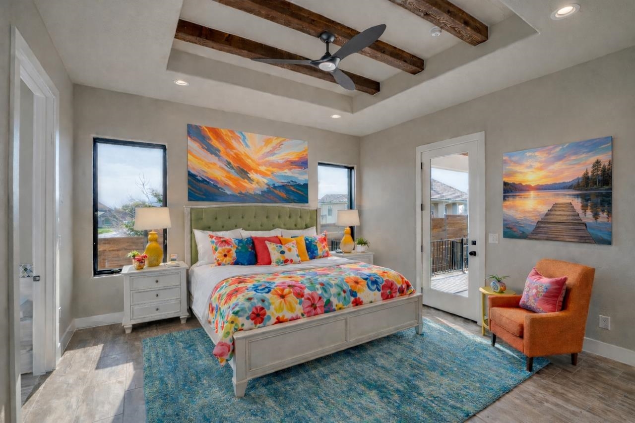 Beamed ceilings and a door the patio, large windows. What a nice bright airy primary bedroom!
