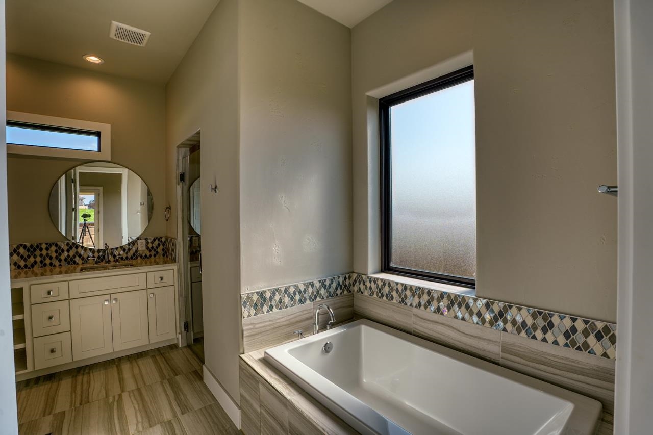 Great window, tub with surround, and designer tile makes this a very special room.
