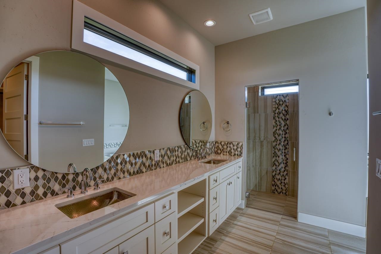 Designer tile and great floor tile.  The large narrow window over the sinks is unique.