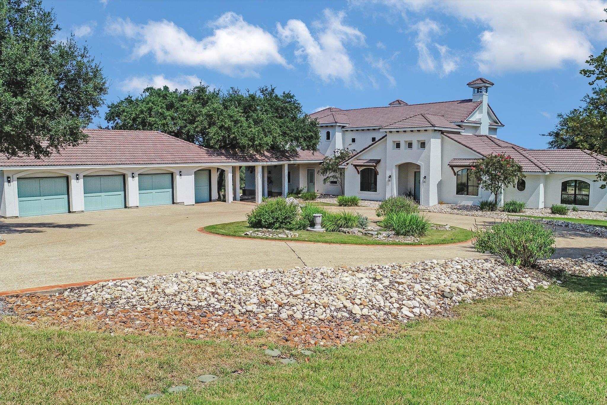 Attached 4 car garage with covered boat bay and workshop