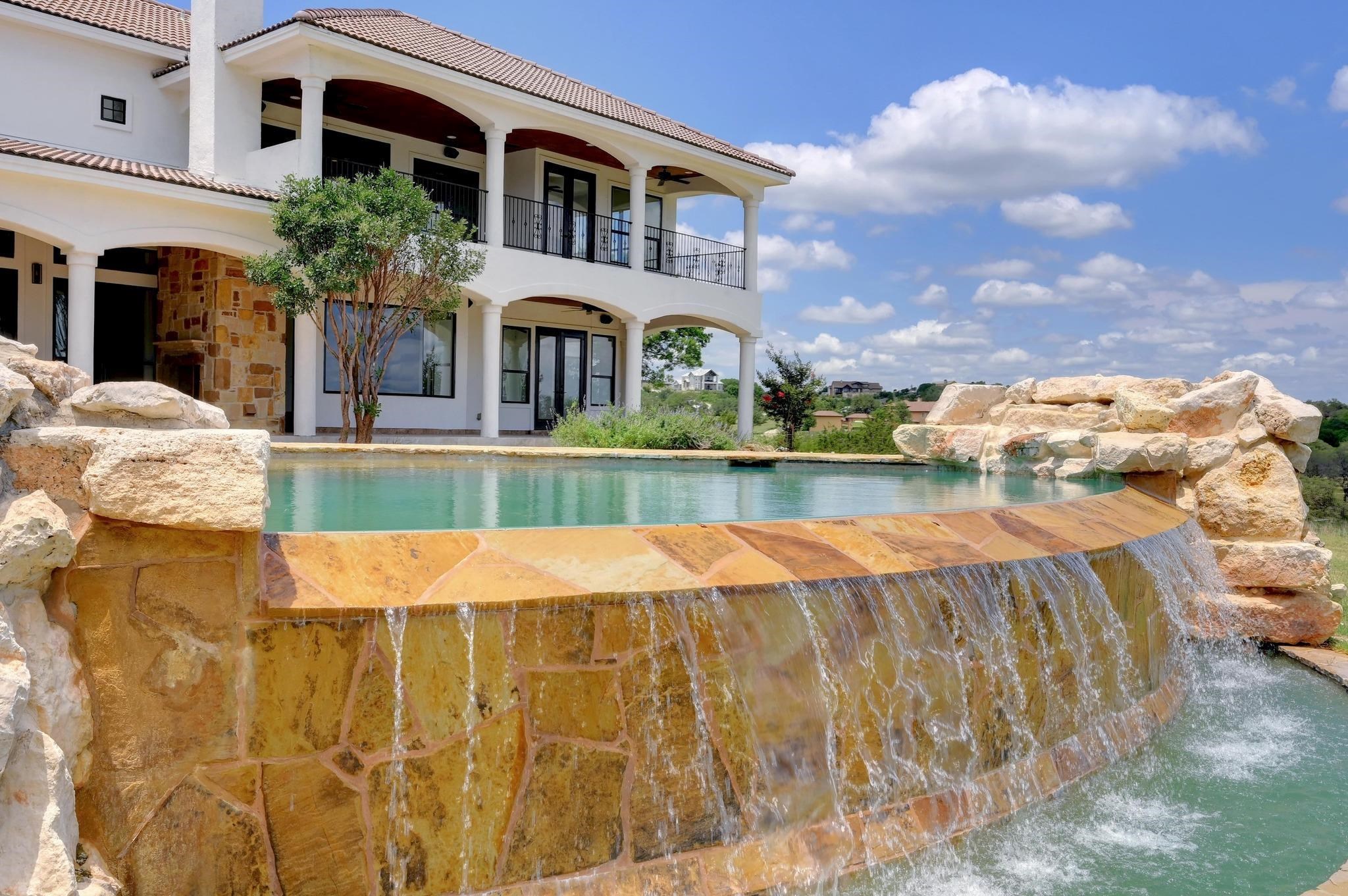 Infinity edge pool with rock faceted waterfalls