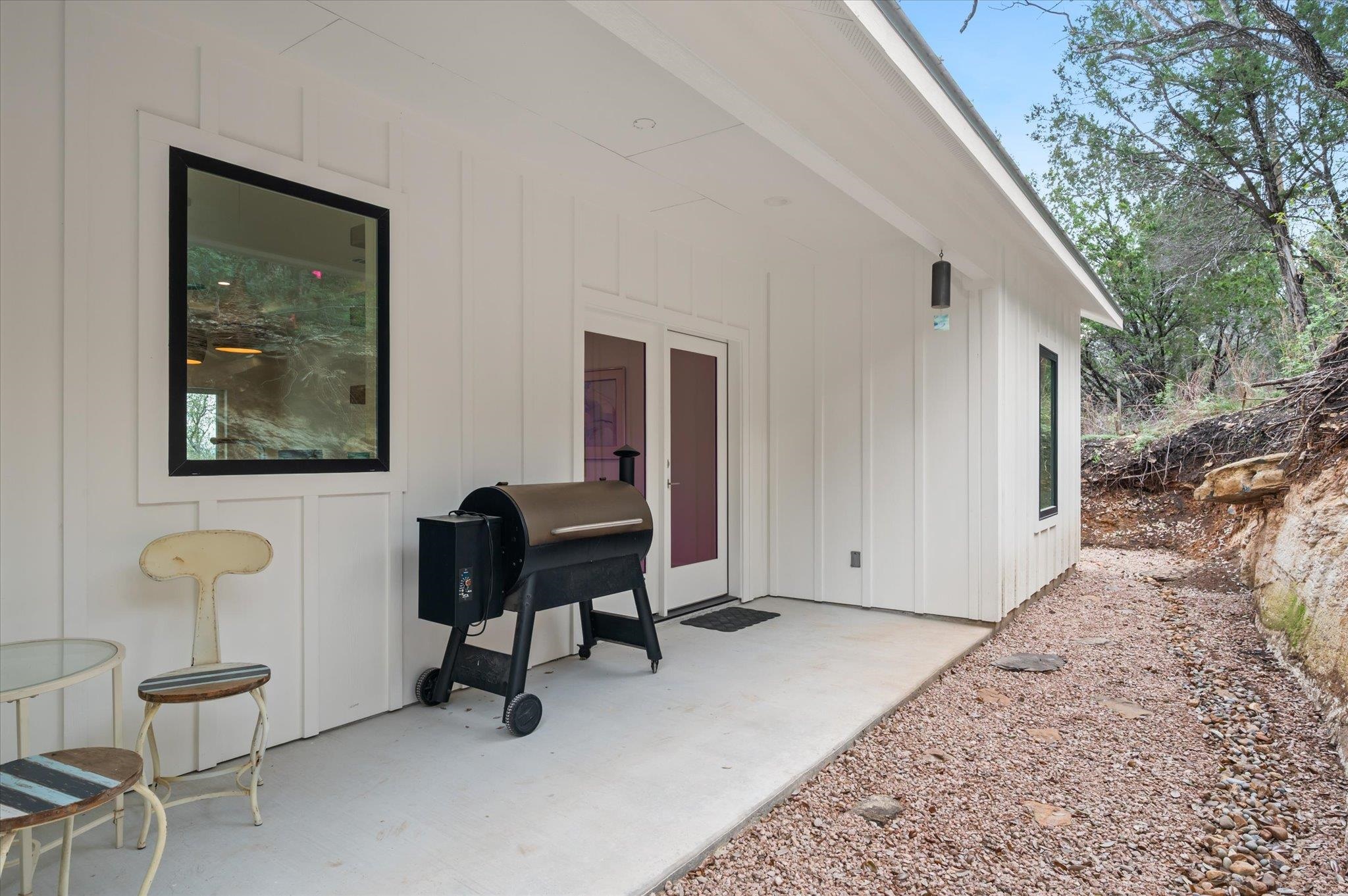 Covered Back Porch with landscaped river rock and local granite yard
