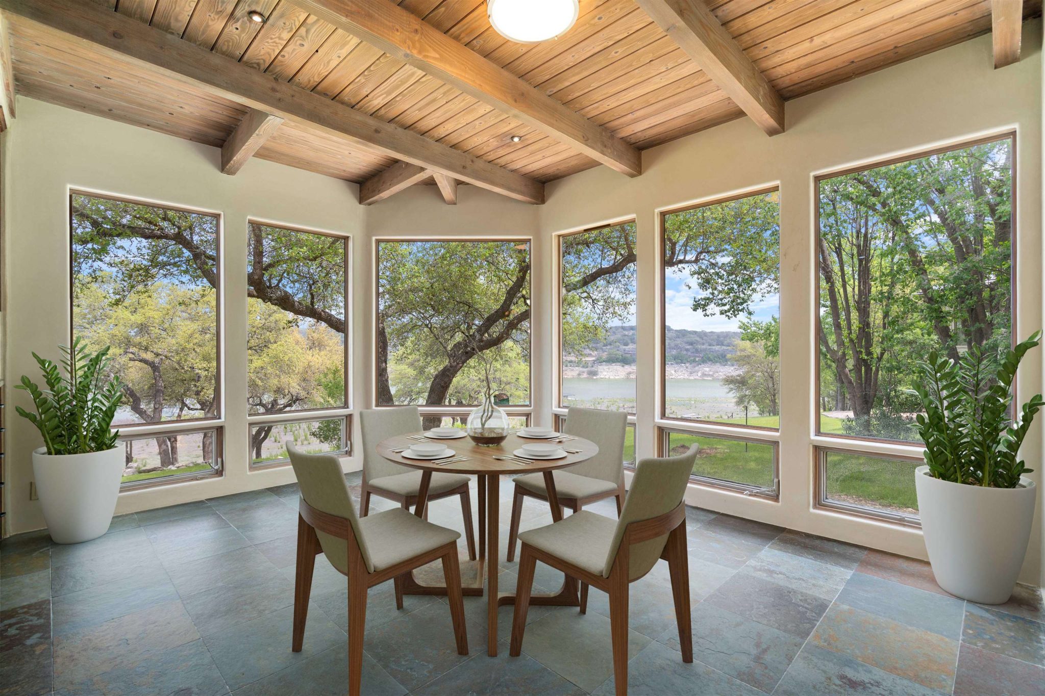 Walls of windows to enjoy the lake views from many rooms in the home. (virtual staging)