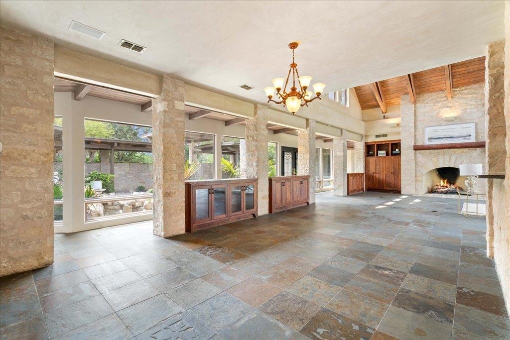 Dining room with views of the lush courtyard and open to the Great Room and kitchen