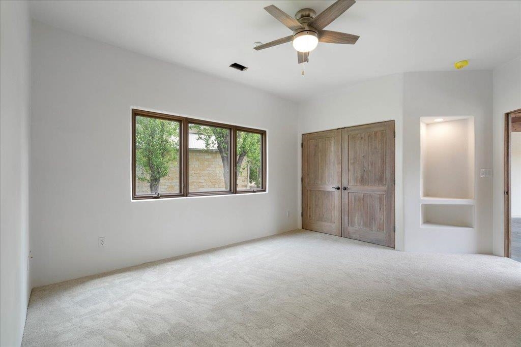 Secondary bedroom 1 and freshly redone walls of venetian plaster and new carpet (both in 2025)