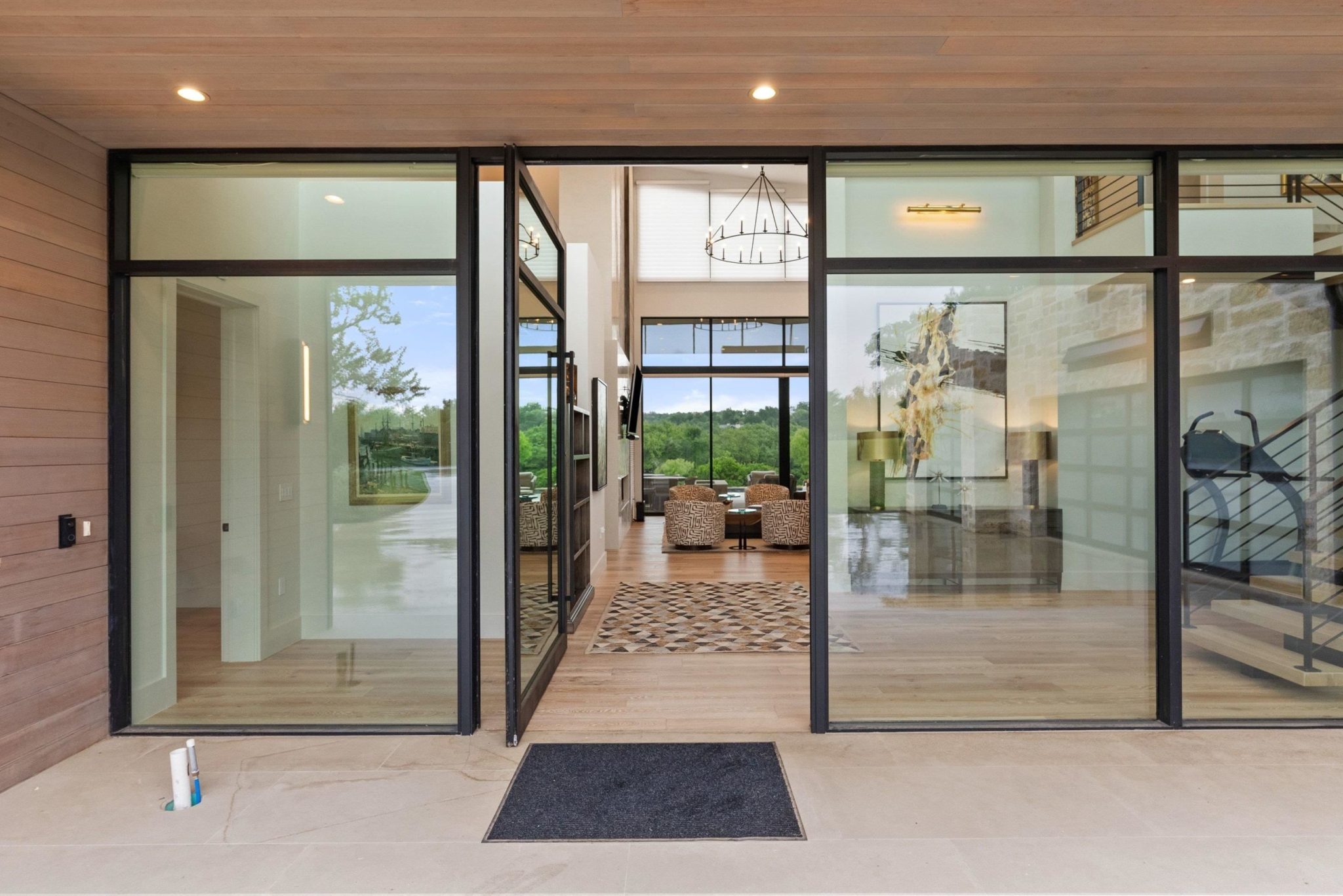 Large custom pivot door welcomes you into this stunning home
