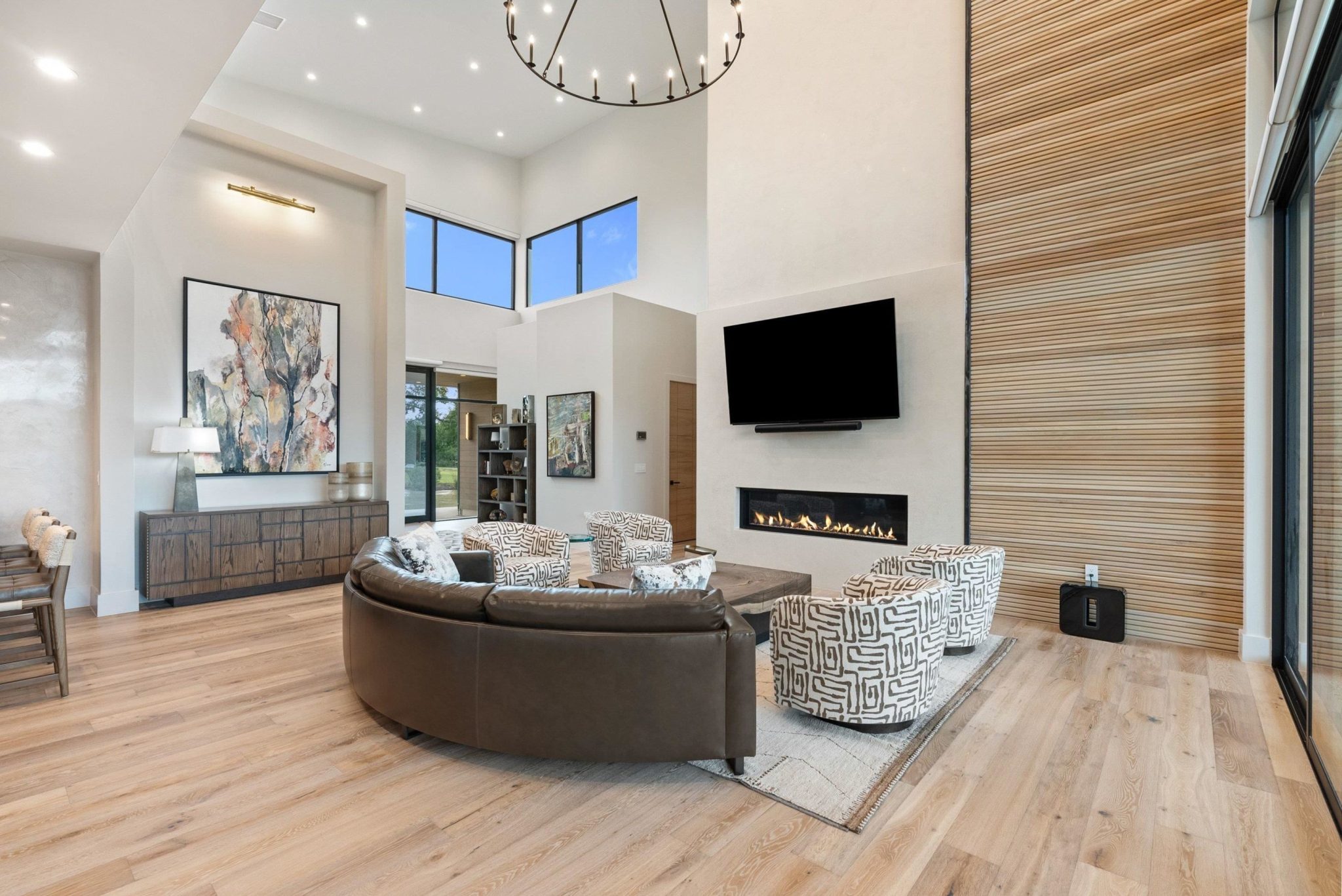 Amazing white oak tambour and plaster fireplace showcase thoughtful artistry in the living area