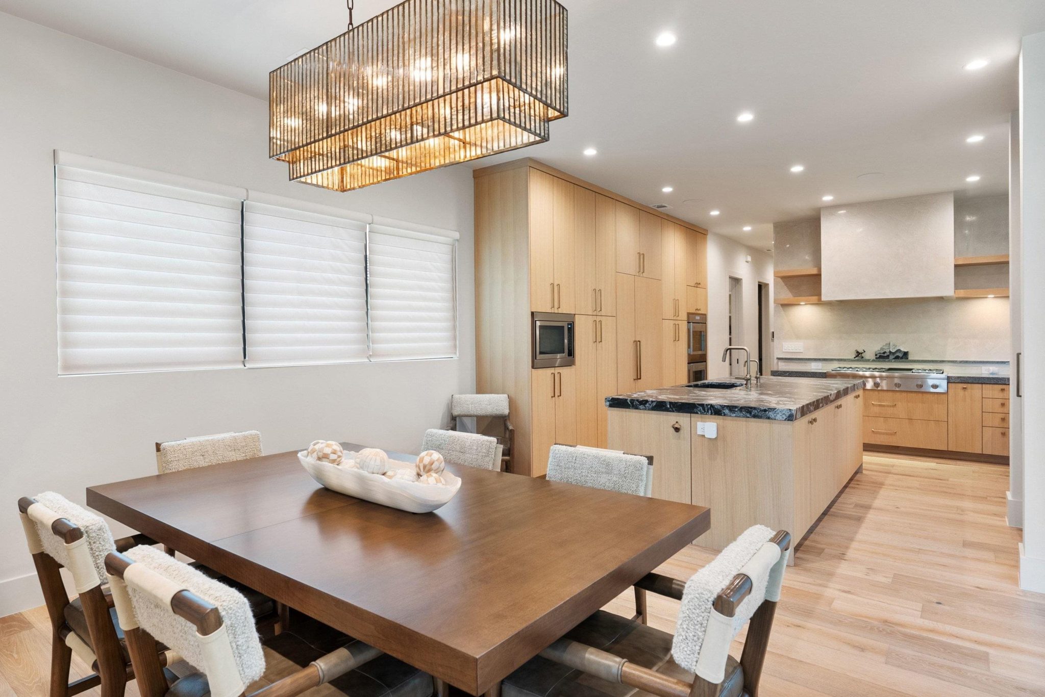 Dazzling designer lighting fixture showcases the large dining area