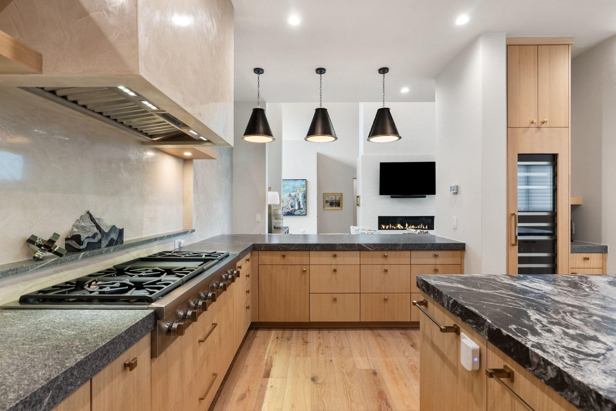 Venetian plaster wall, a generously tall sized wine refrigerator, and Thermador appliances