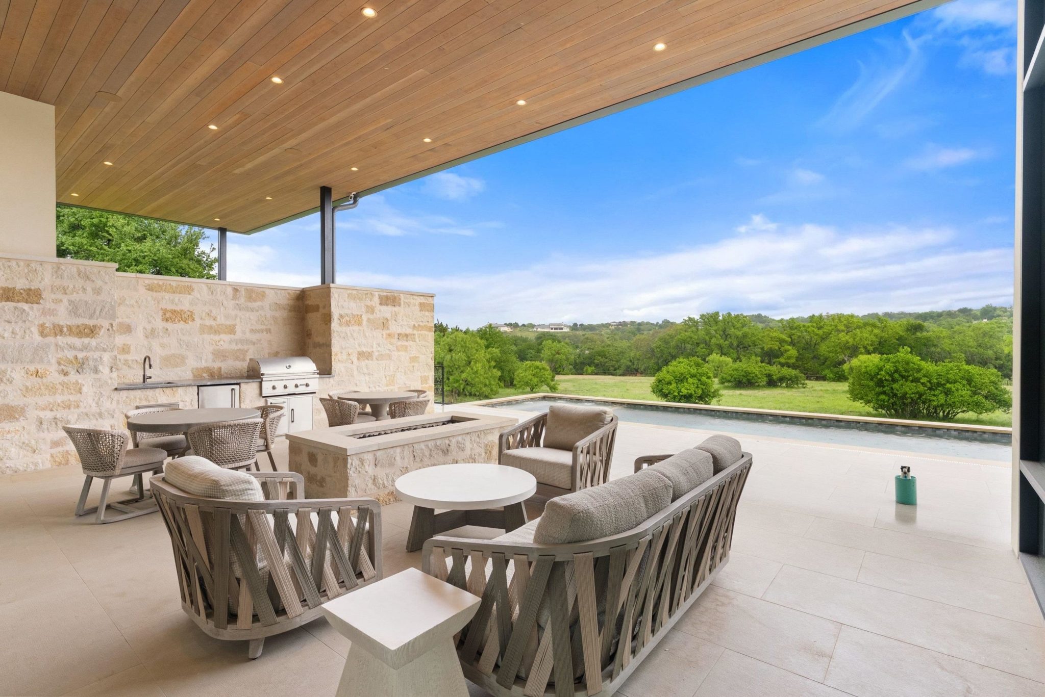 Covered back patio with room for various sitting areas, an outdoor kitchen and views!