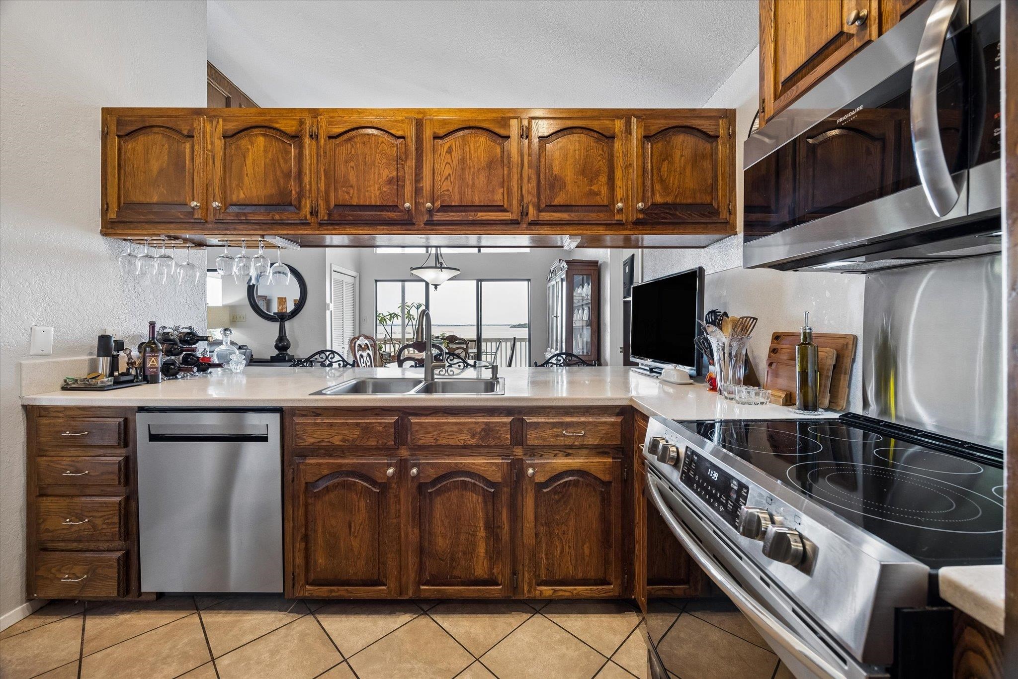 Prepare meals in this kitchen, boasting ample cabinetry and a convenient pass-through window to the