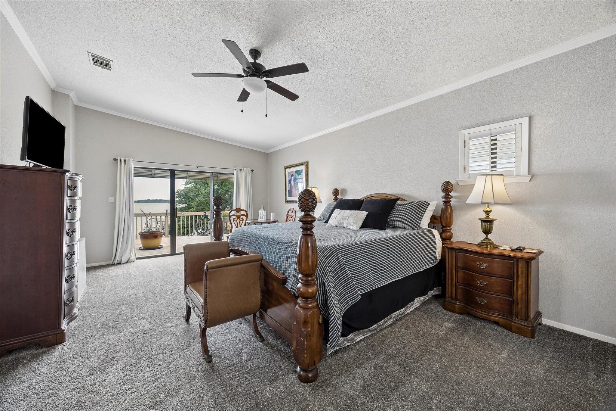 Large upstairs master bedroom with access to deck overlooking the lake.