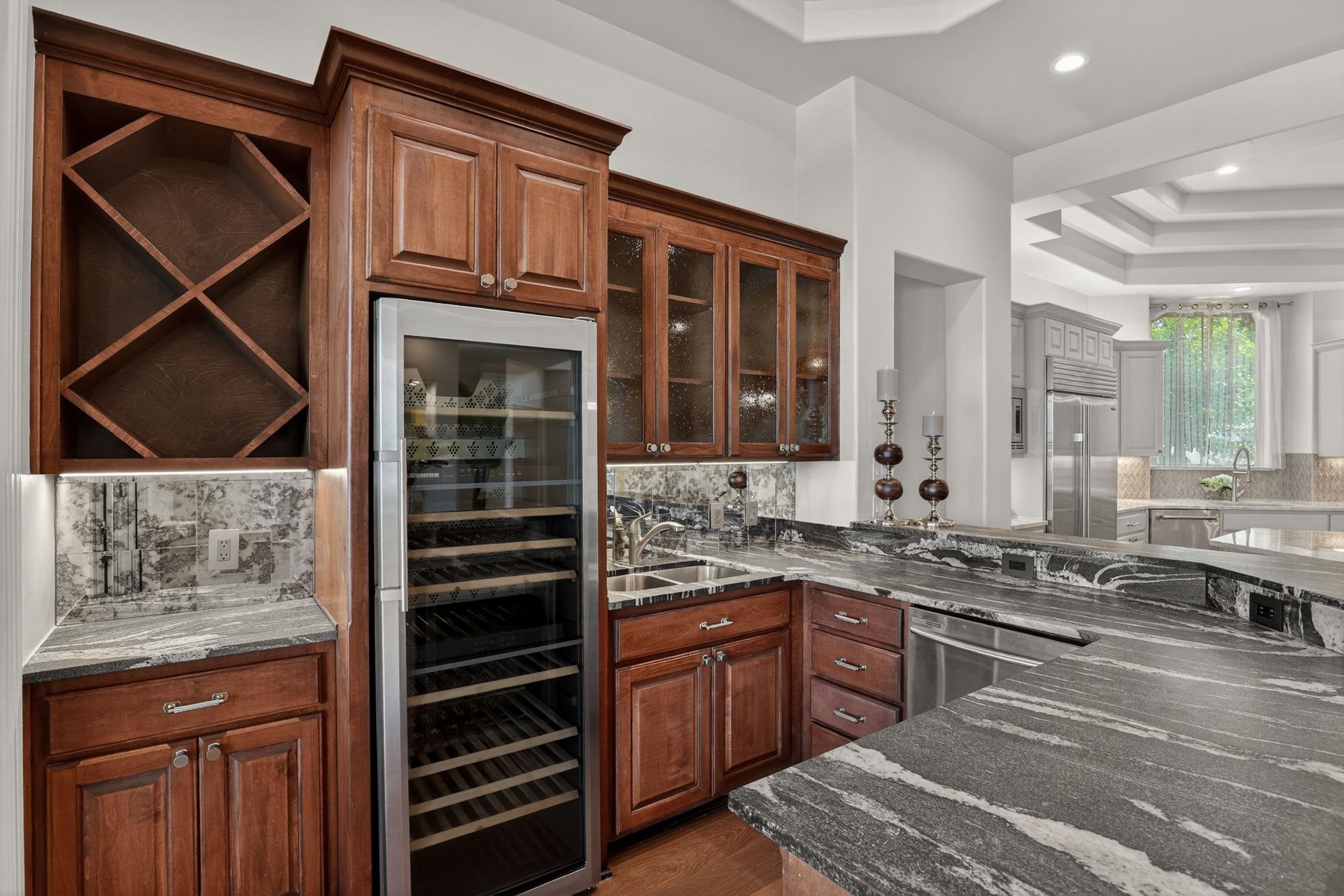 STYLISH WET BAR...JUST STEPS AWAY FROM PATIO KITCHEN, ISLAND, GRILL, DINING, POOL & LAKE AMENITIES!