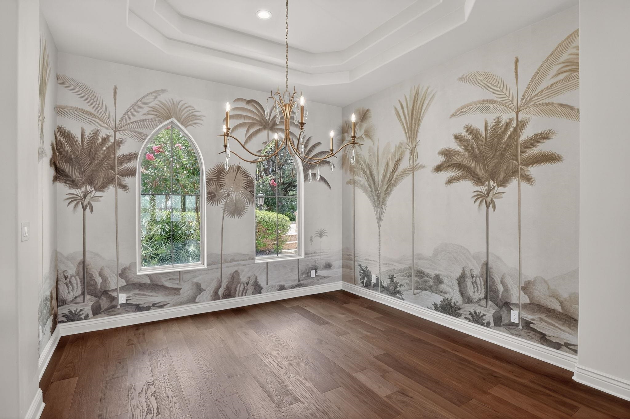 DINE WITH PARADISE IN MIND, ENJOYING THIS PALM TREE LANDSCAPE MURAL & SOPHISTICATED CHANDELIER.