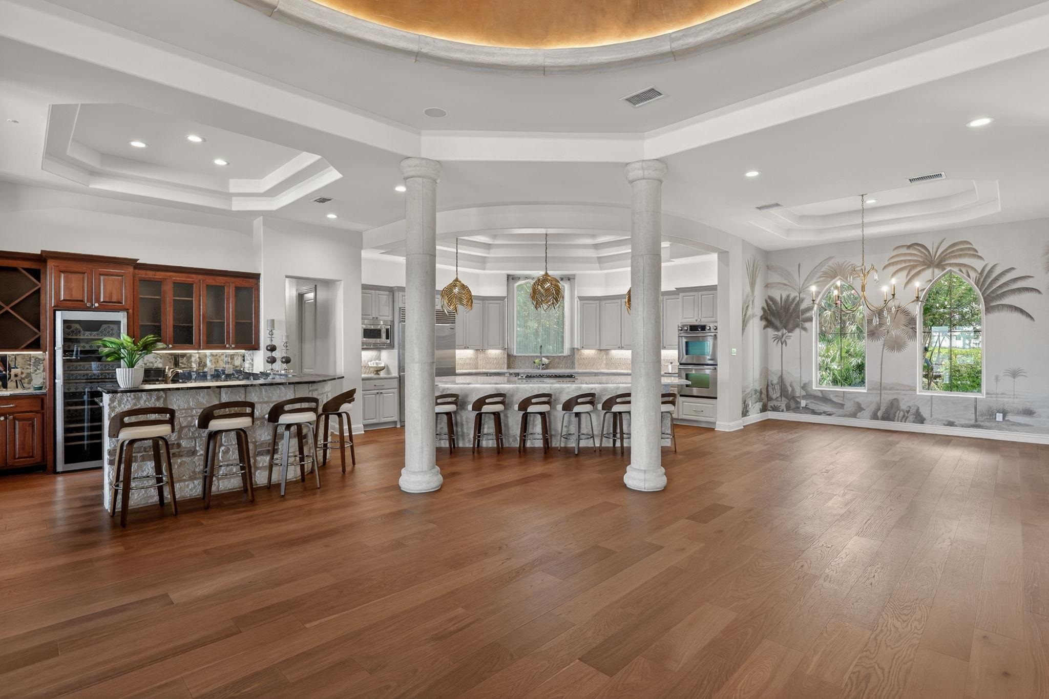 A DREAM KITCHEN, STRIKING WET BAR AND DINING AREA WITH UNFORGETTABLE PALM TREE LANDSCAPE MURAL!