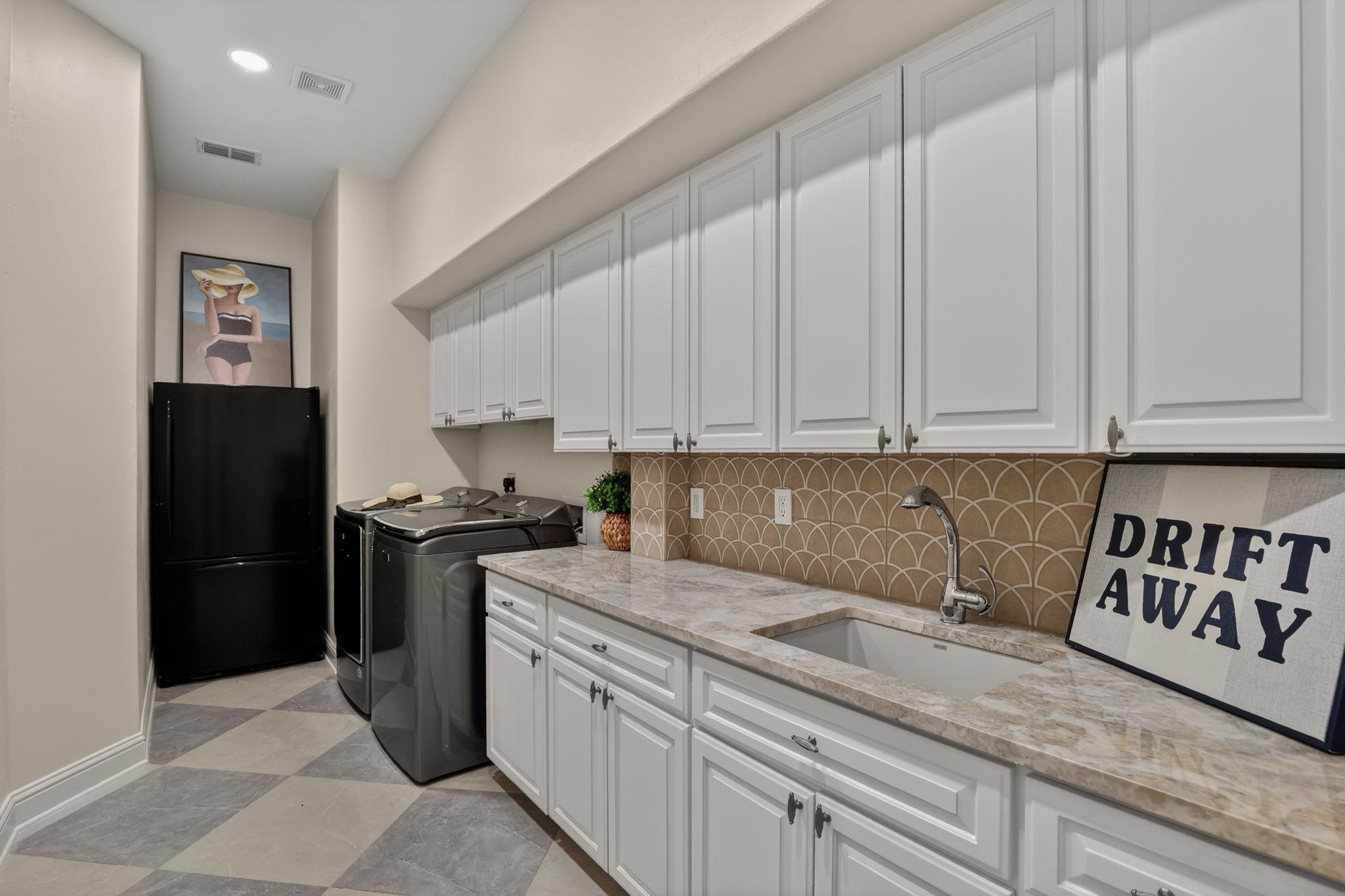 LAUNDRY ROOM WITH 2026 UPDATED SLEEK DESIGN, BOLD TILES, STONE COUNTERTOPS & STORAGE!