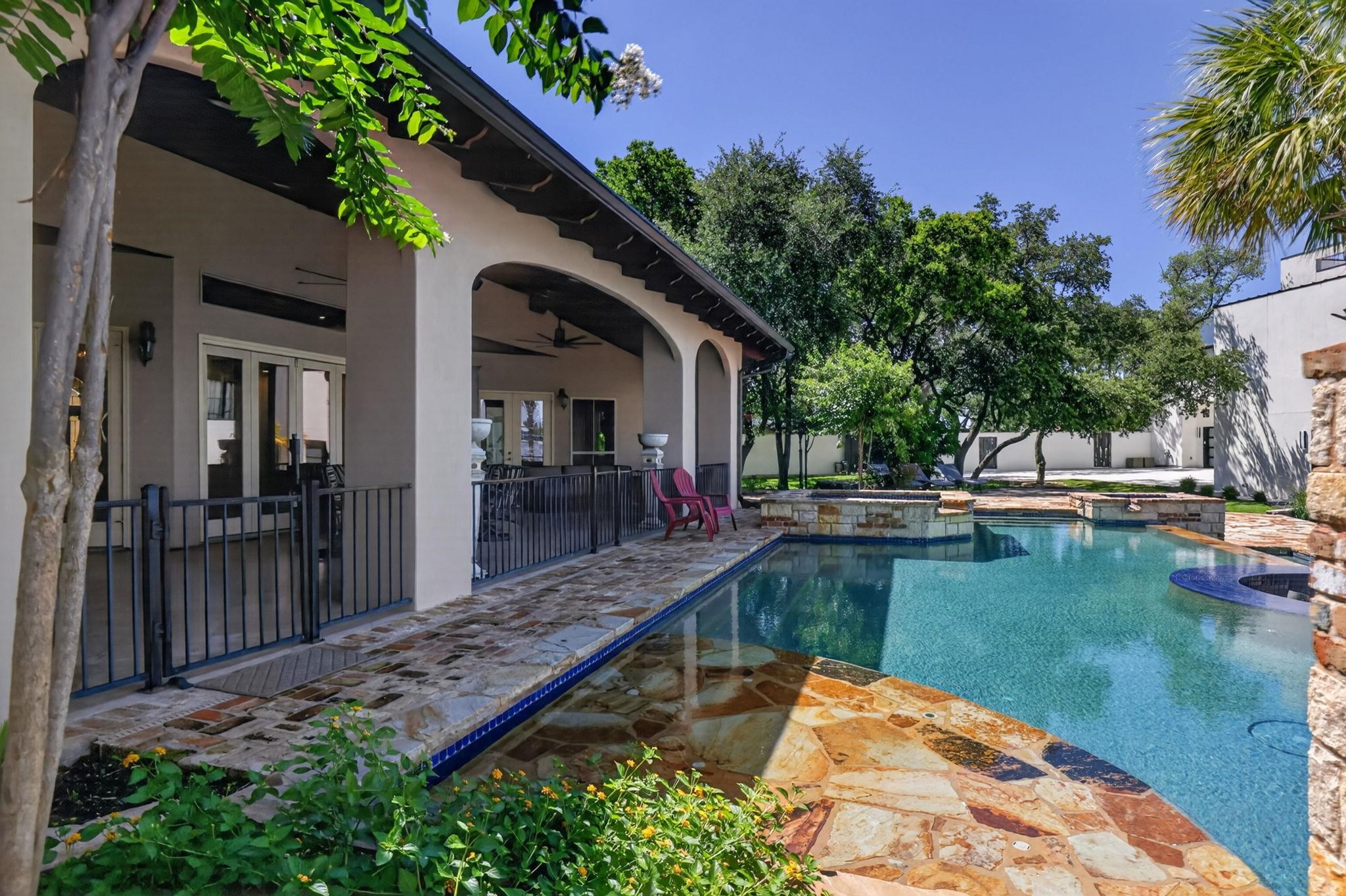 MULTIPLE POOL AREAS! EXPANSIVE PATIO WITH OUTDOOR KITCHEN, TV'S, FIREPLACE & DINING! IT'S ALL HERE!!
