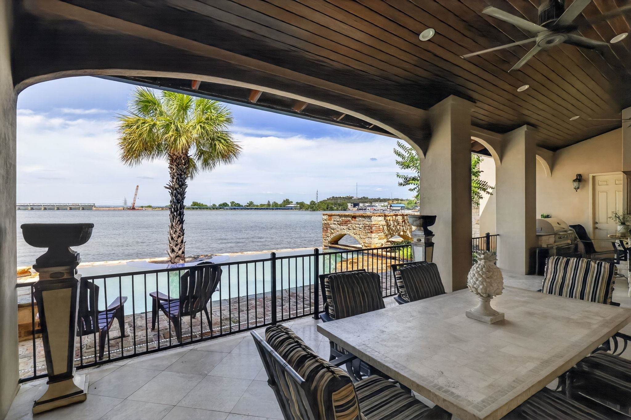 NOTICE THE HANDSOME PLANK CEILING & SAFETY RAIL! IT'S DINNER PARTY TIME (IN FLIP-FLOPS) AT LAKE LBJ!