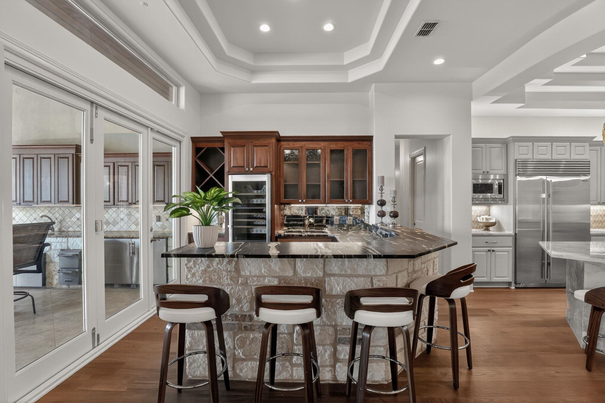 TIMELESS LEATHERED GRANITE COUNTERTOPS, STONE BASE, SINK, ANTIQUED MIRROR BACKSPLASH, WINE STORAGE!