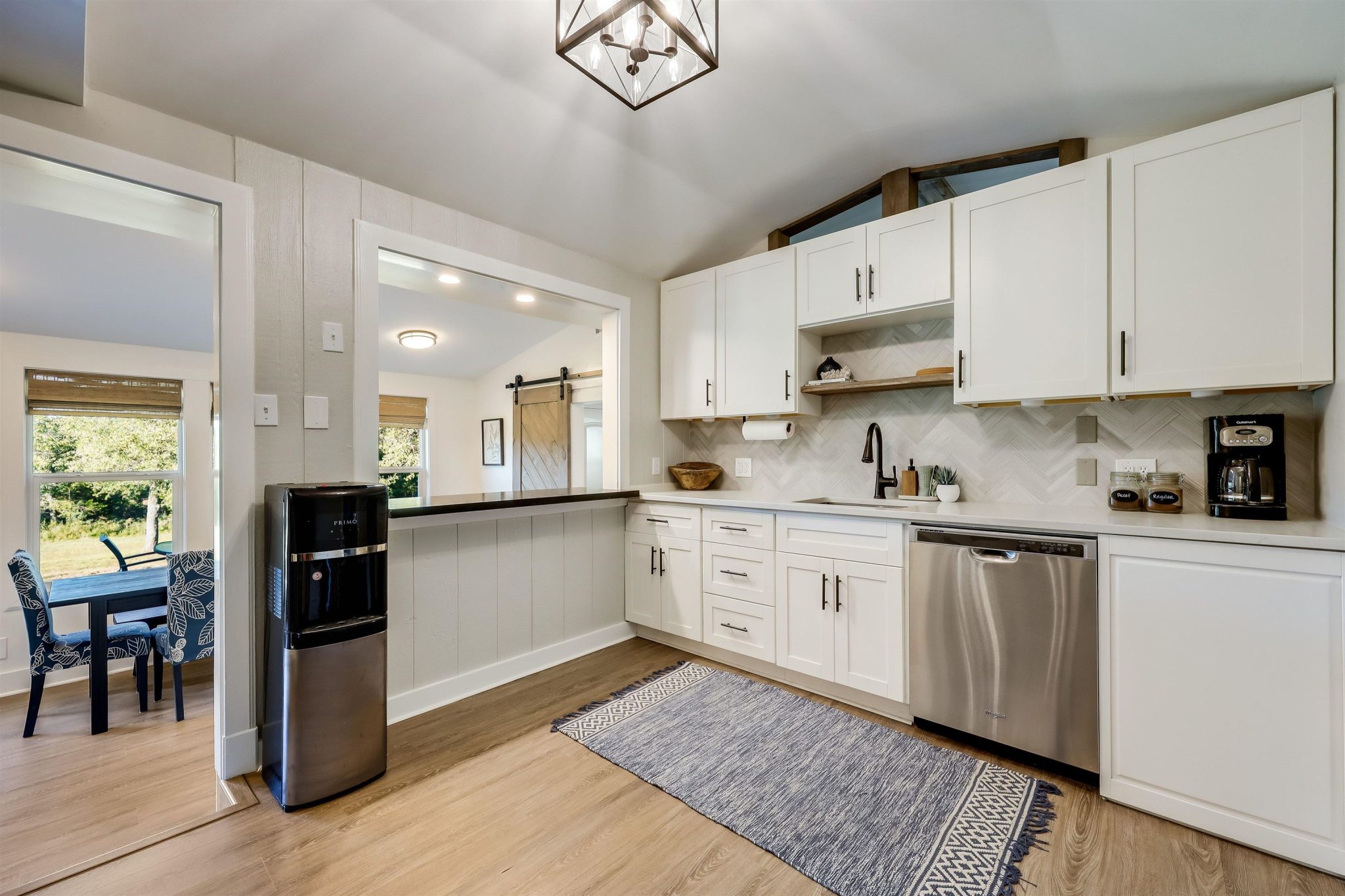 Beautifully remodeled kitchen with stainless steel appliances, stylish backsplash