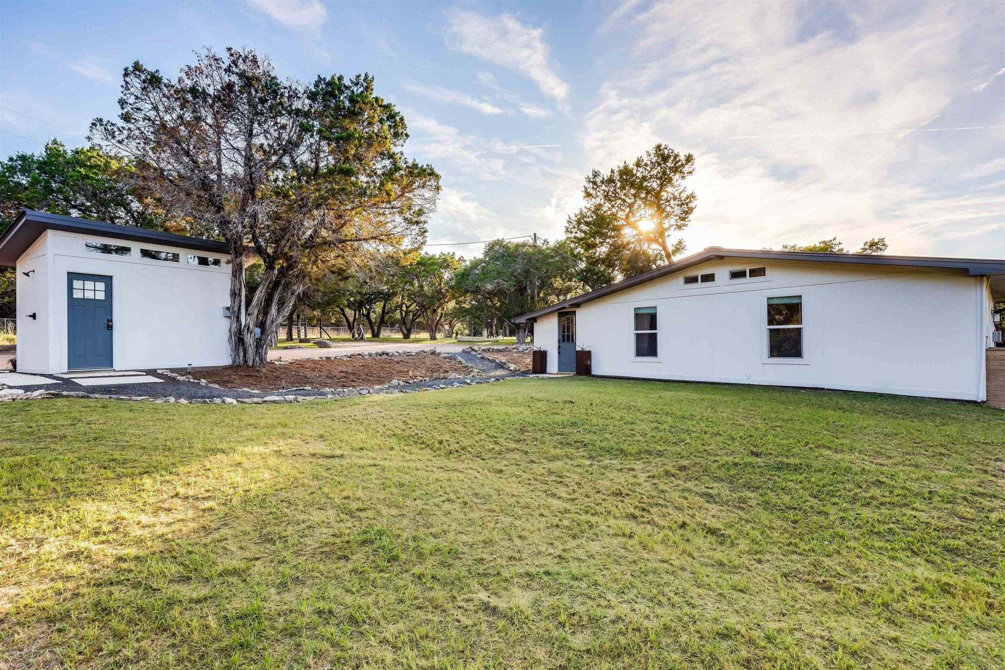 Front of the home and well house/laundry room with outdoor shower