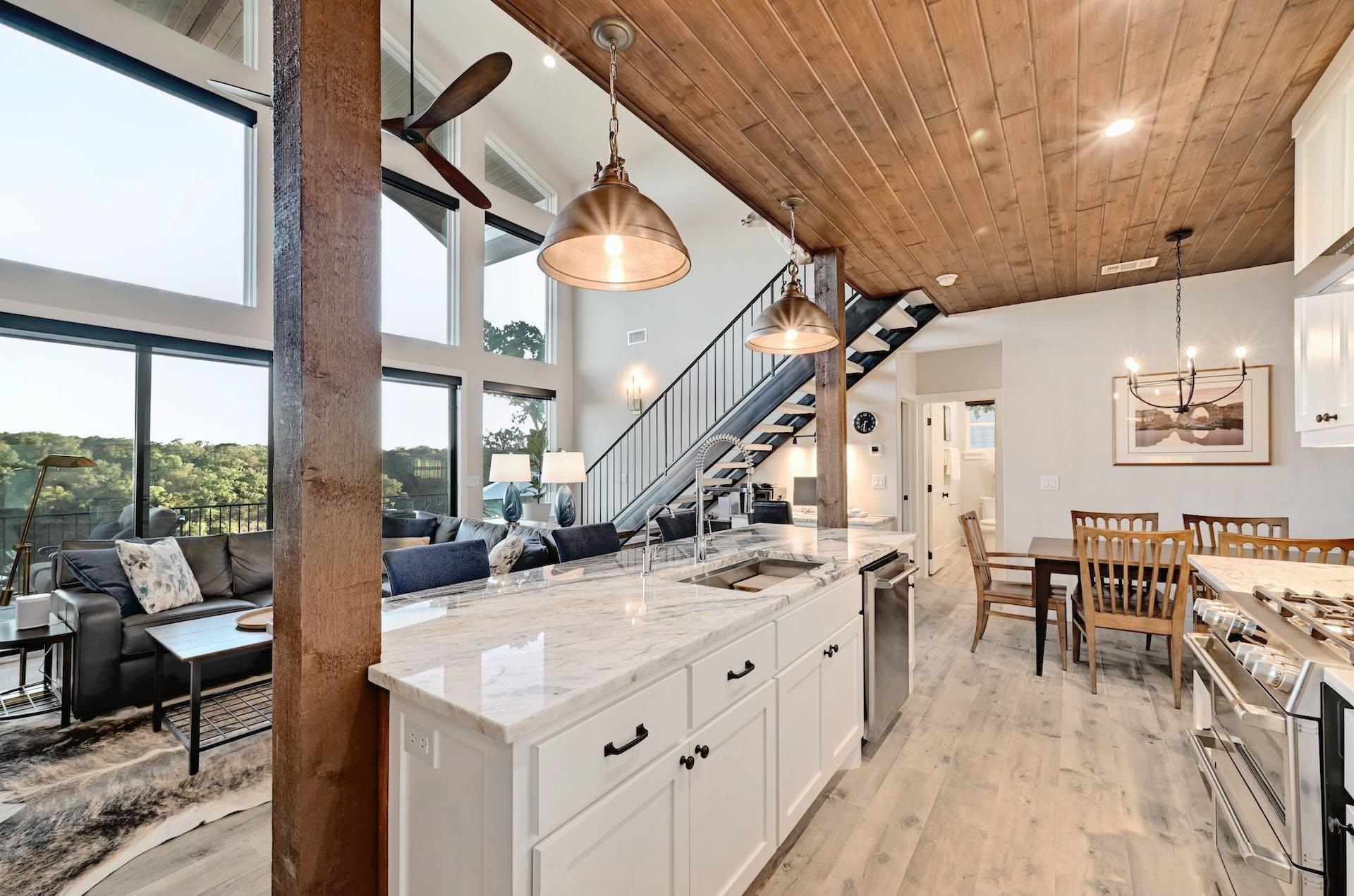 The kitchen features white cabinets, granite counters, stainless steel appliances, propane gas range