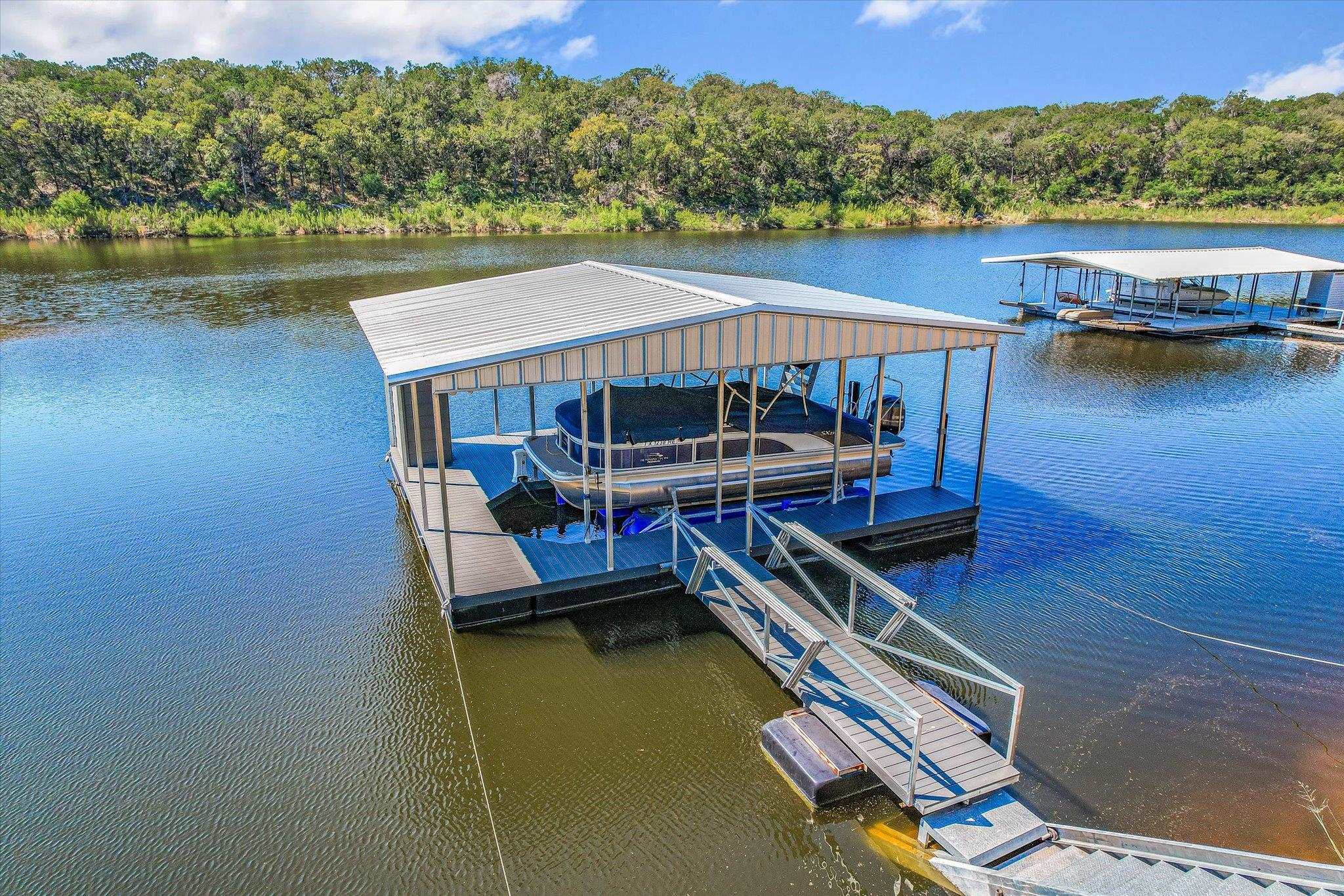 Private waterfront includes a boat dock with an 8,800-pound HydroHoist® boat lift