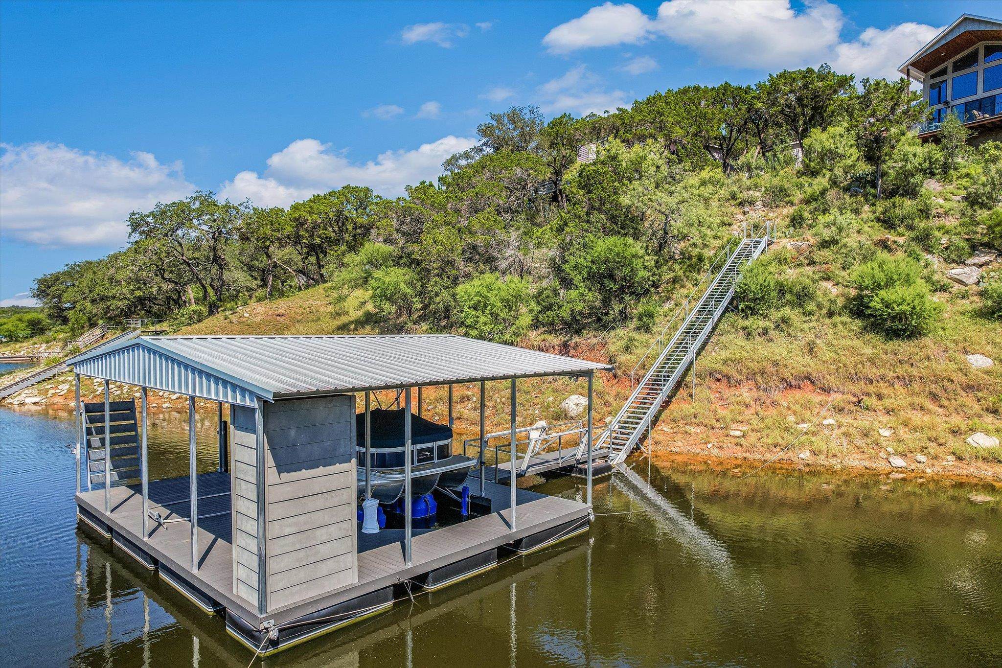 Walkway and boat dock. New owner could install a tram if desired.