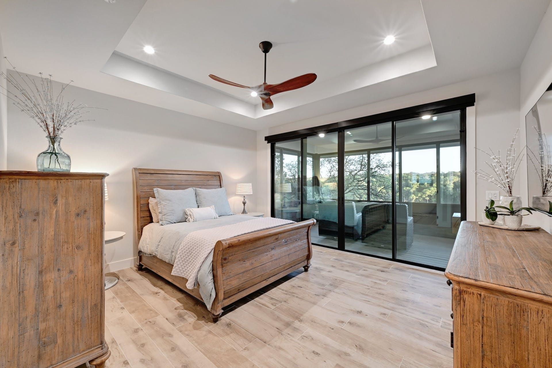 The primary suite opens to a screened porch —an inviting spot to enjoy coffee, wine and sunsets.