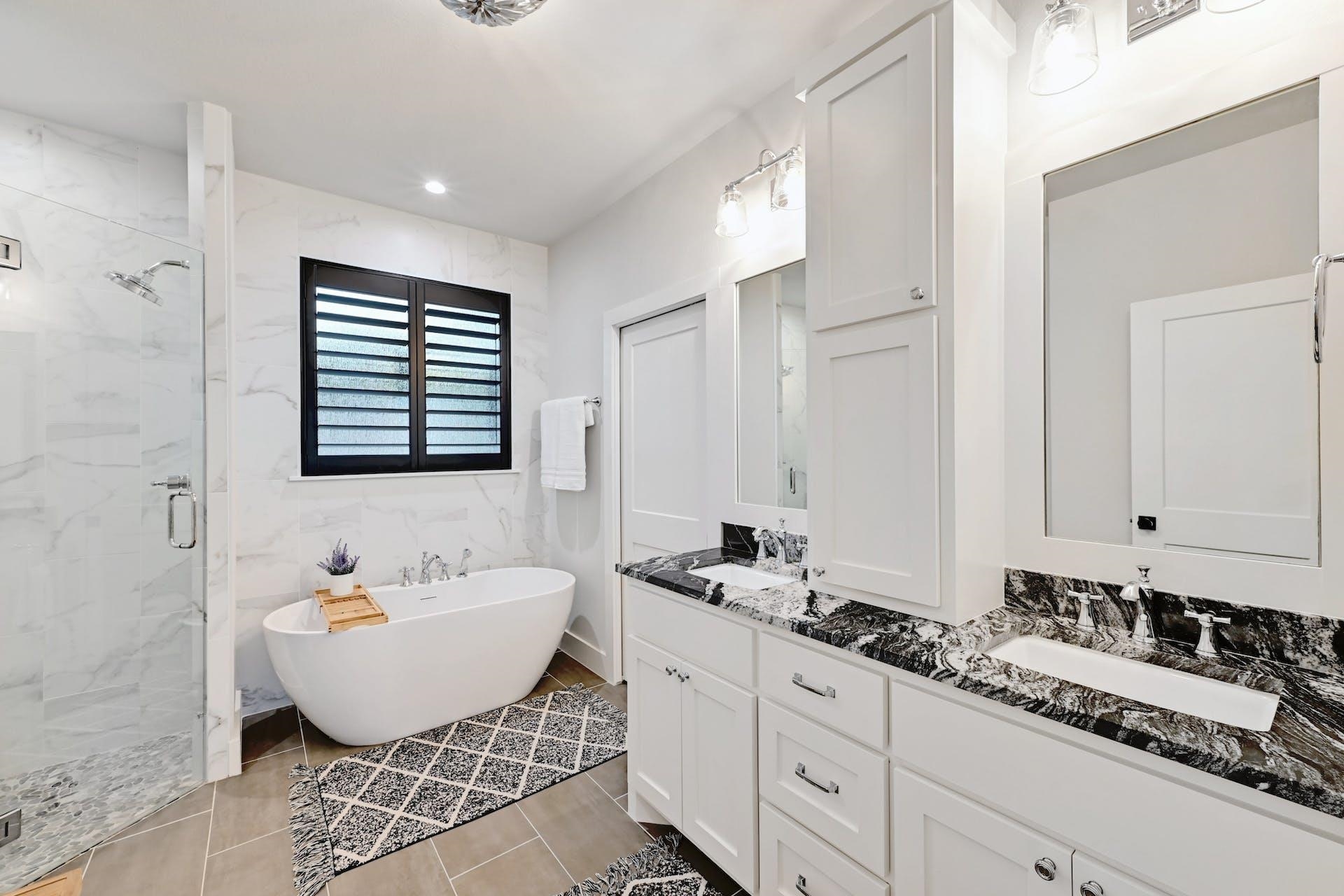 Primary bath features dual vanities with granite tops, deep soaking tub and separate shower.