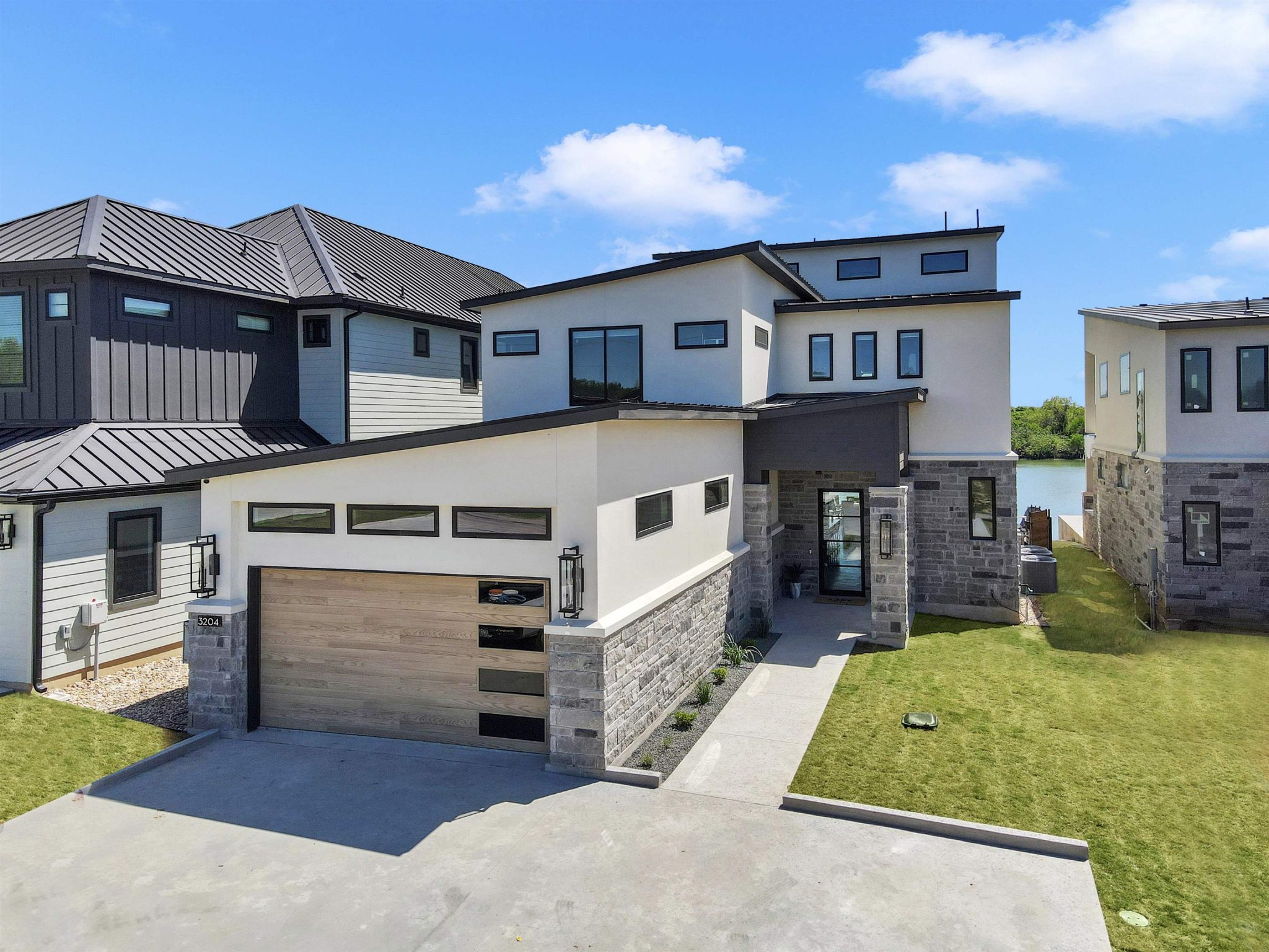 Striking contemporary architecture pairs smooth stucco with textured stone masonry.