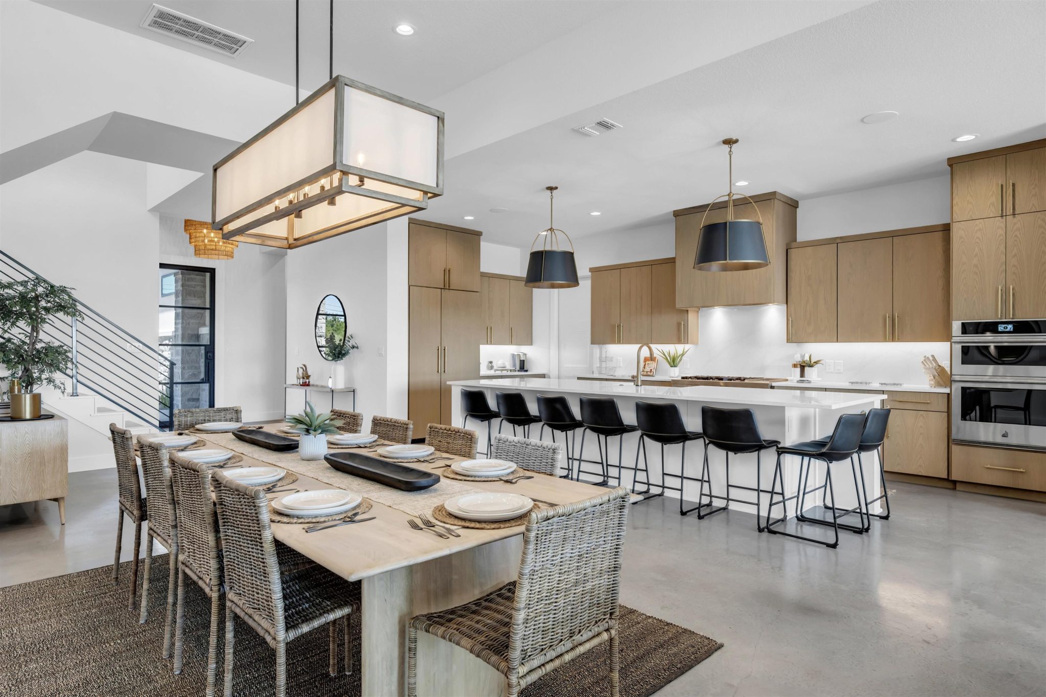 Gleaming concrete floors flow seamlessly throughout this open-concept culinary and dining space.