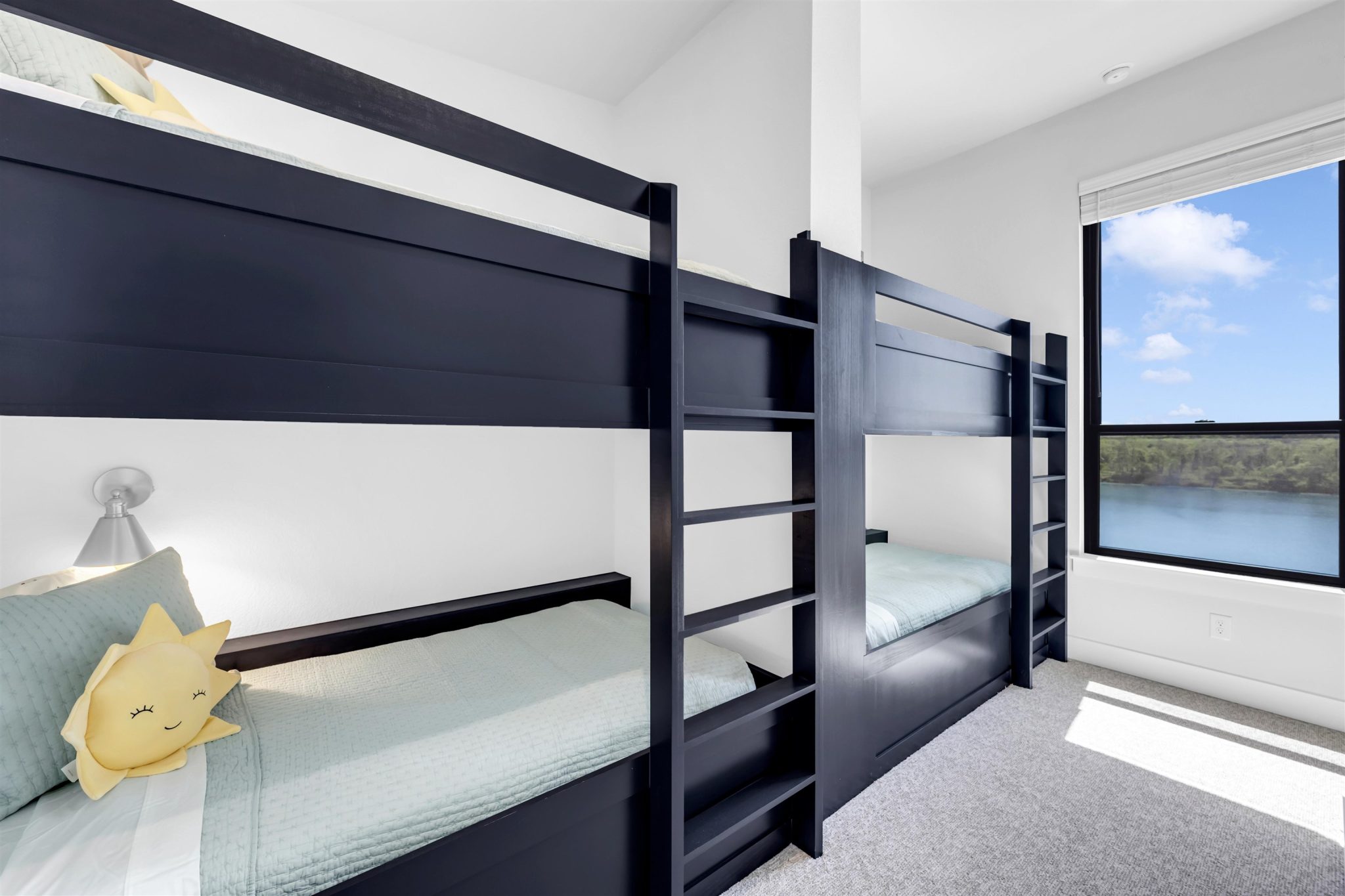 Bedroom eight: Custom built-in bunk beds. Sunlight streams through the large window.