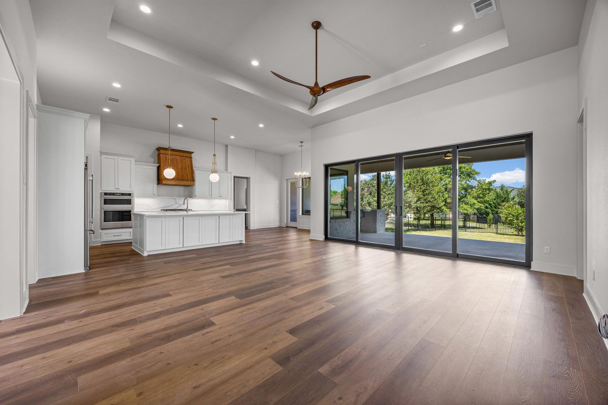 Beautiful tray ceiling and large glass sliding doors seamlessly connect to the outdoors.