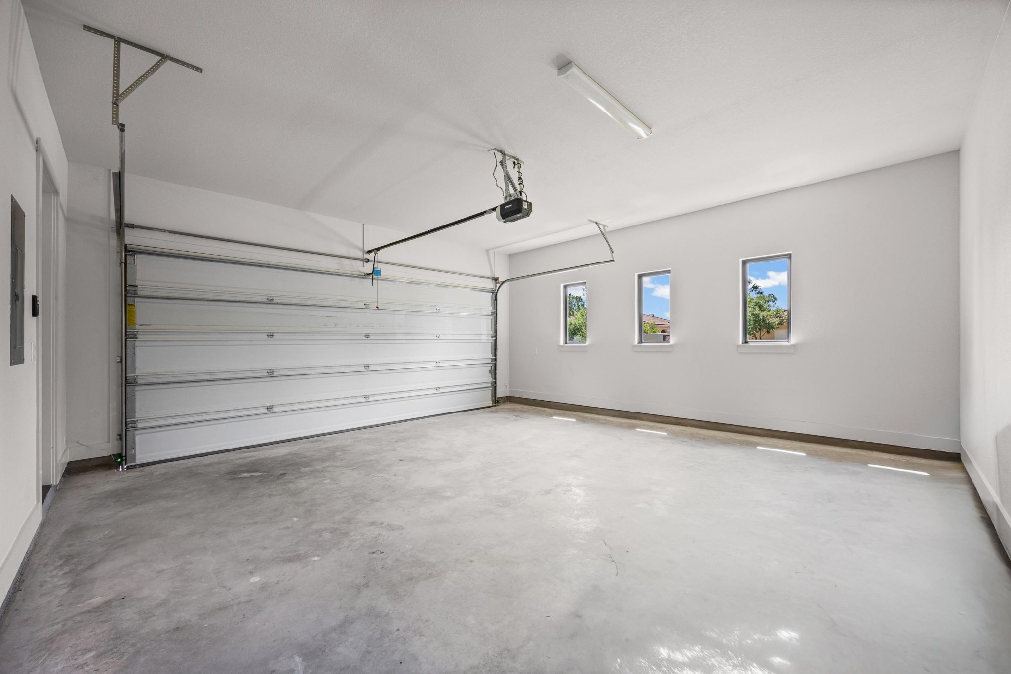 Pristine and finished garage provides ample room for vehicles and storage.