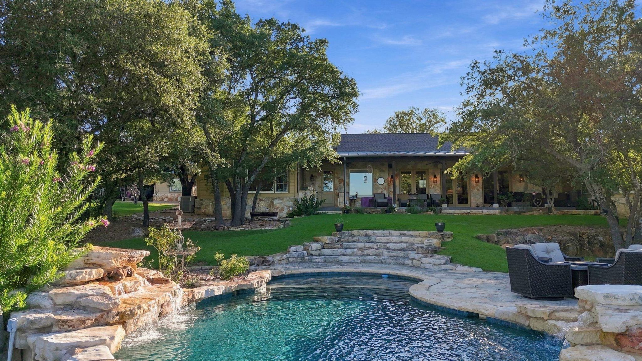 Resort-style pool becomes the centerpiece of the home's outdoor living spaces.