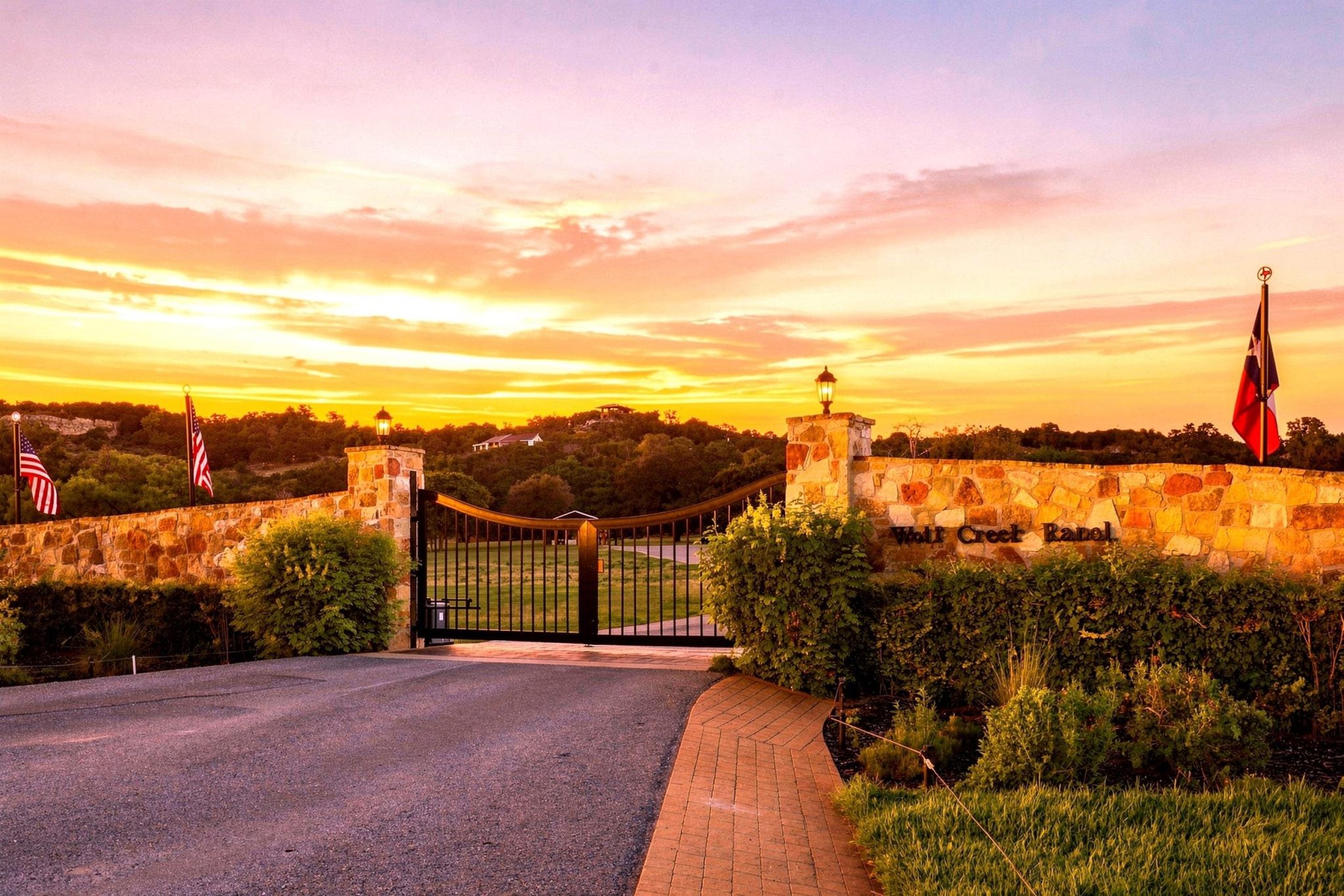 Impressive main gated entrance to Wolf Creek Ranch framed in native stone.