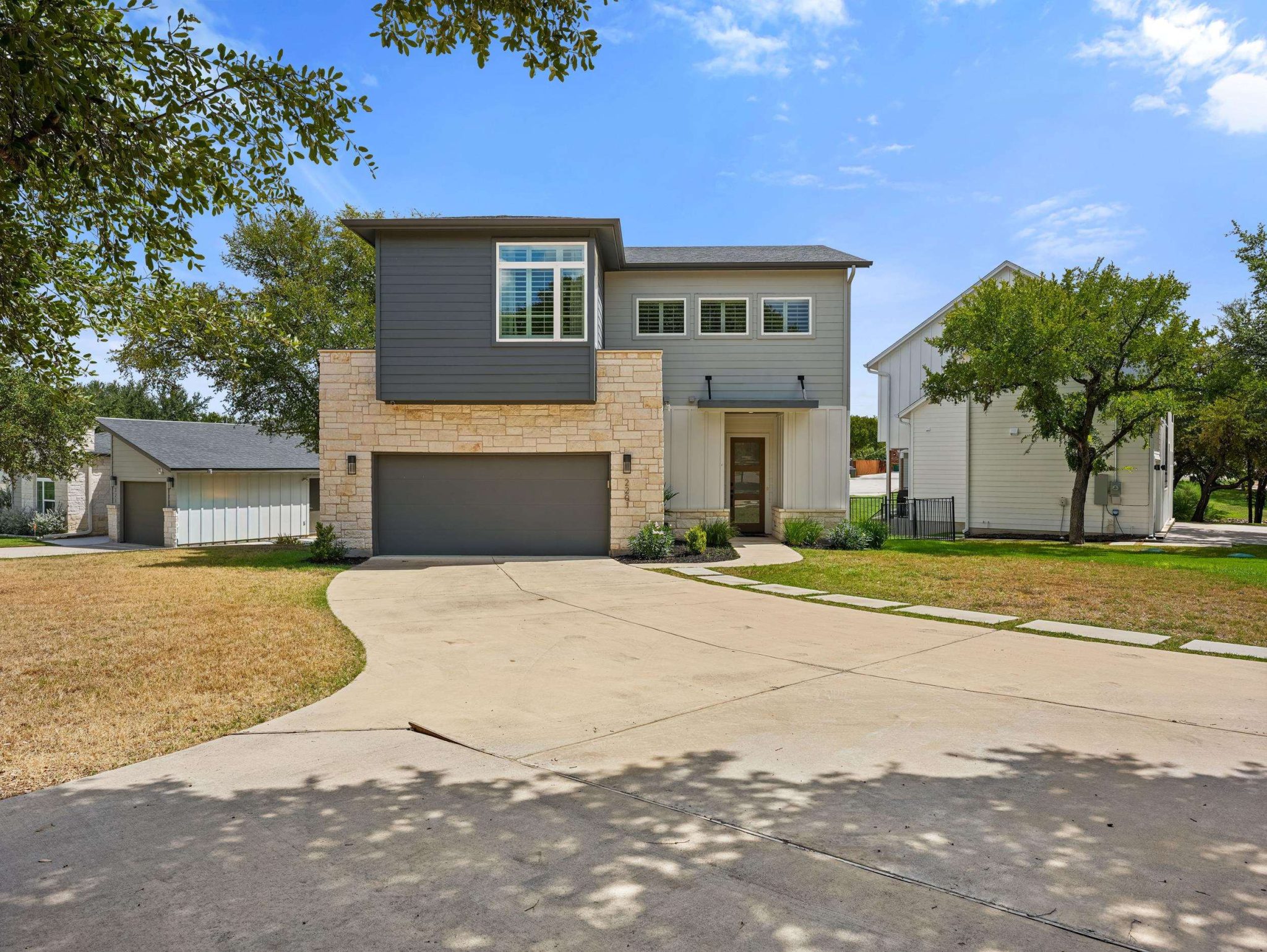 Clean lines and a spacious driveway define this modern exterior.