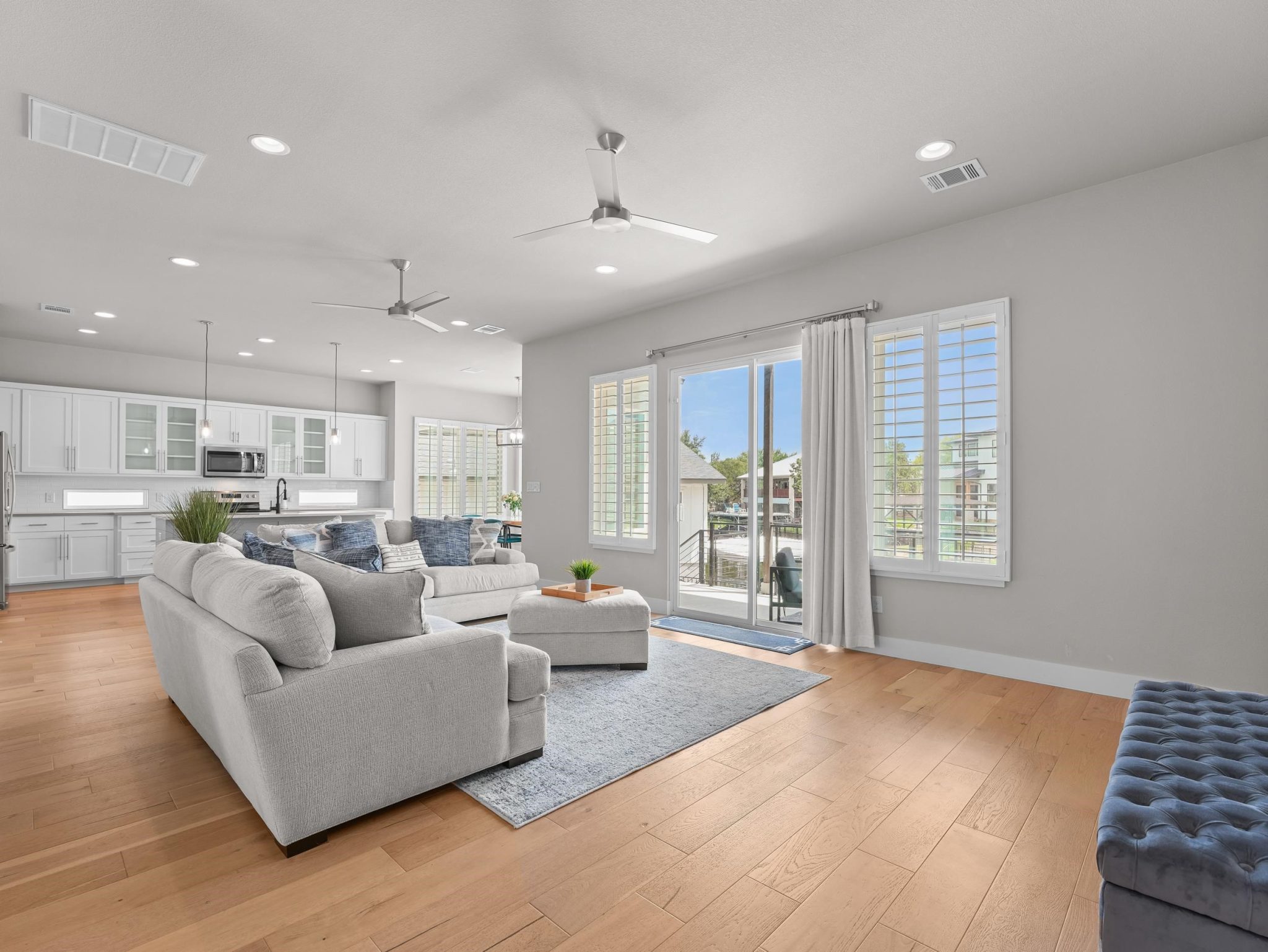Rich hardwood flooring complements the bright, open-plan layout connecting the main living spaces.