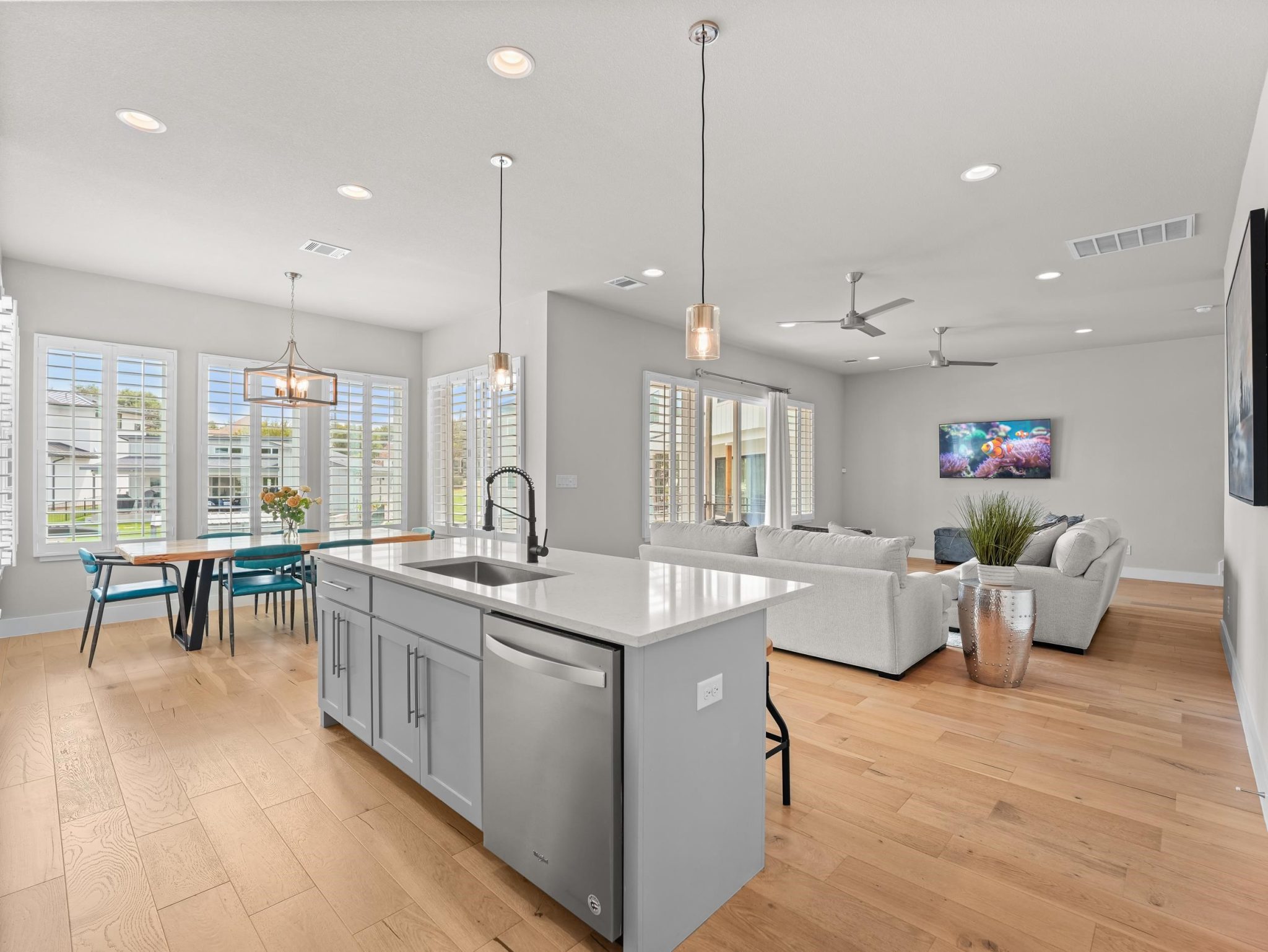 Gleaming hardwood floors and recessed lighting enhance this airy, open-concept living space.