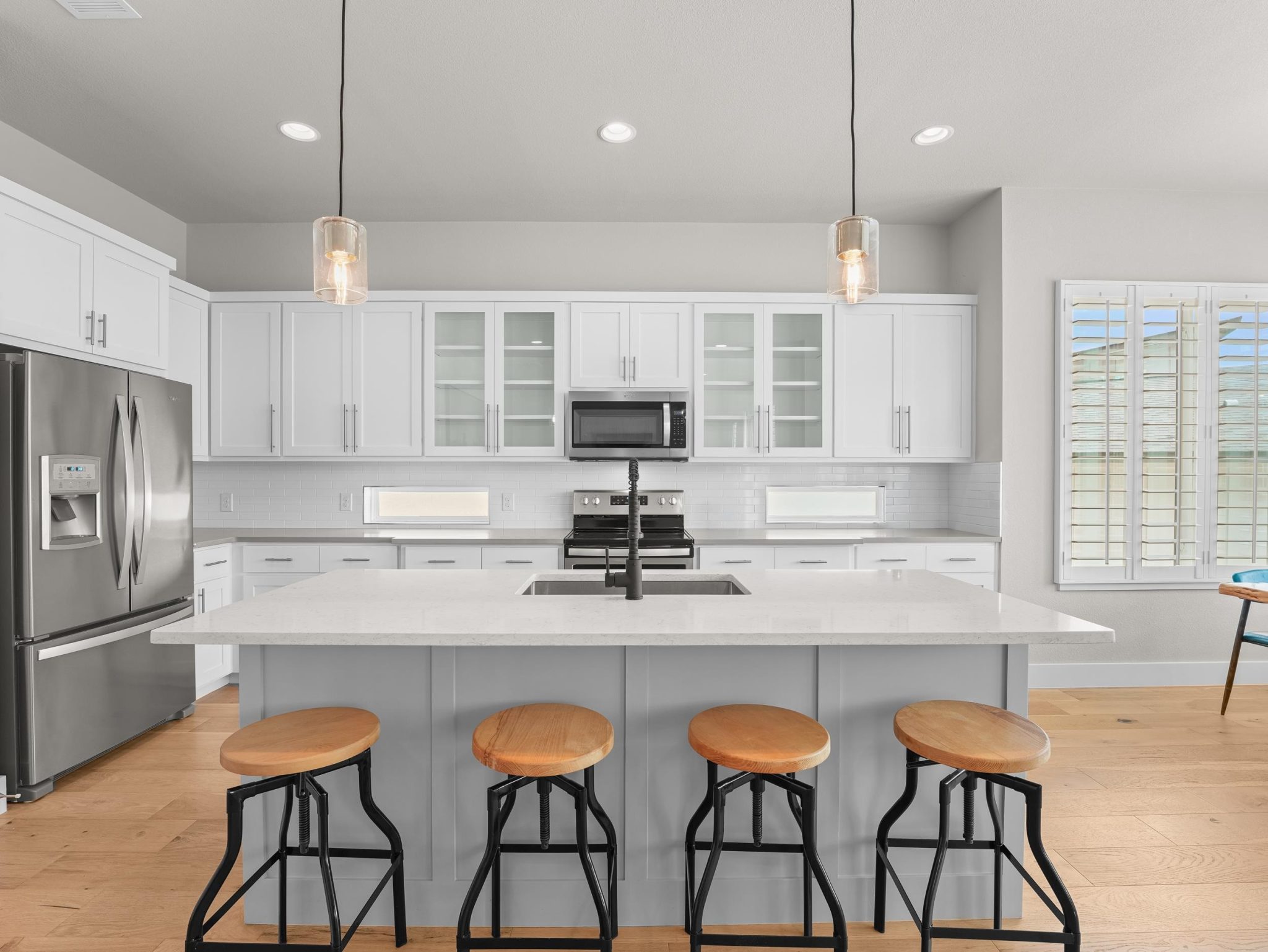 Gleaming stone countertops and a spacious central island define this modern culinary workspace.
