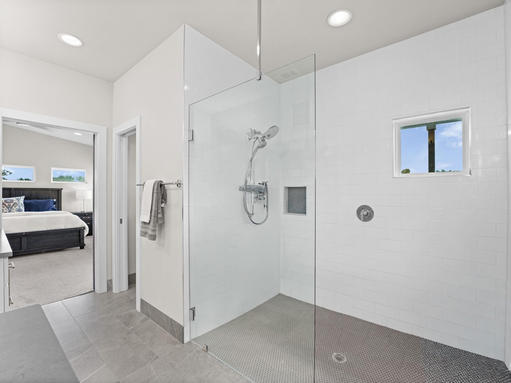 Clean lines and a spacious walk-in shower define this modern, light-filled bathroom space.